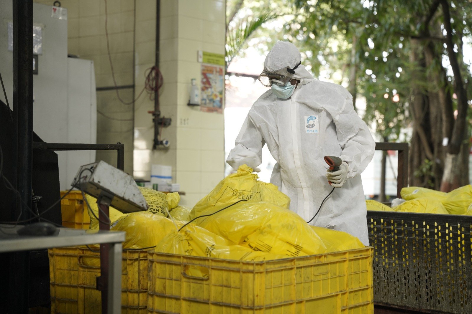 Healthcare Waste Barcode Scanning SMS Envocare operator scanning yellow bio-medical waste bags for tracking before treatment.