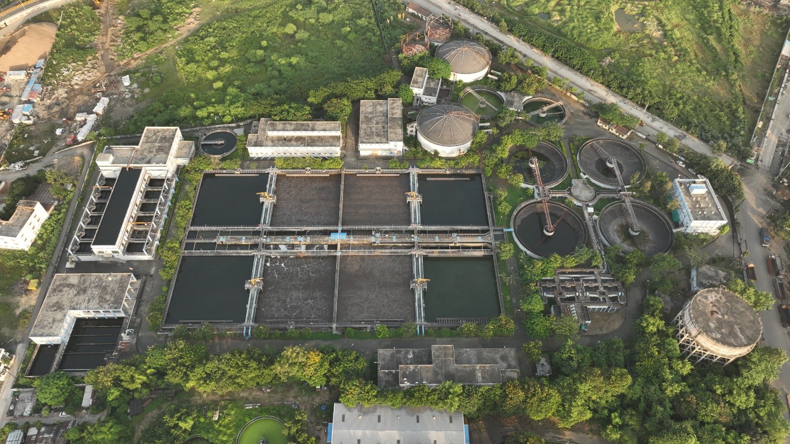 Wastewater Treatment Plant Aerial View Top-down aerial view of wastewater treatment tanks, clarifiers and process buildings at an SMS Envocare facility.